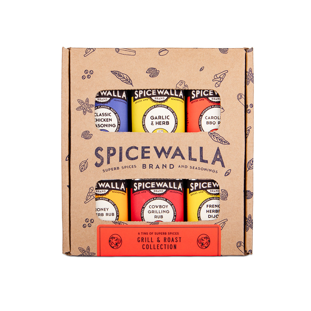 SpiceWalla Grill & Roast Collection in a brown kraft cardboard gift box, showing six seasoning bottles with colorful labels and a red front band.