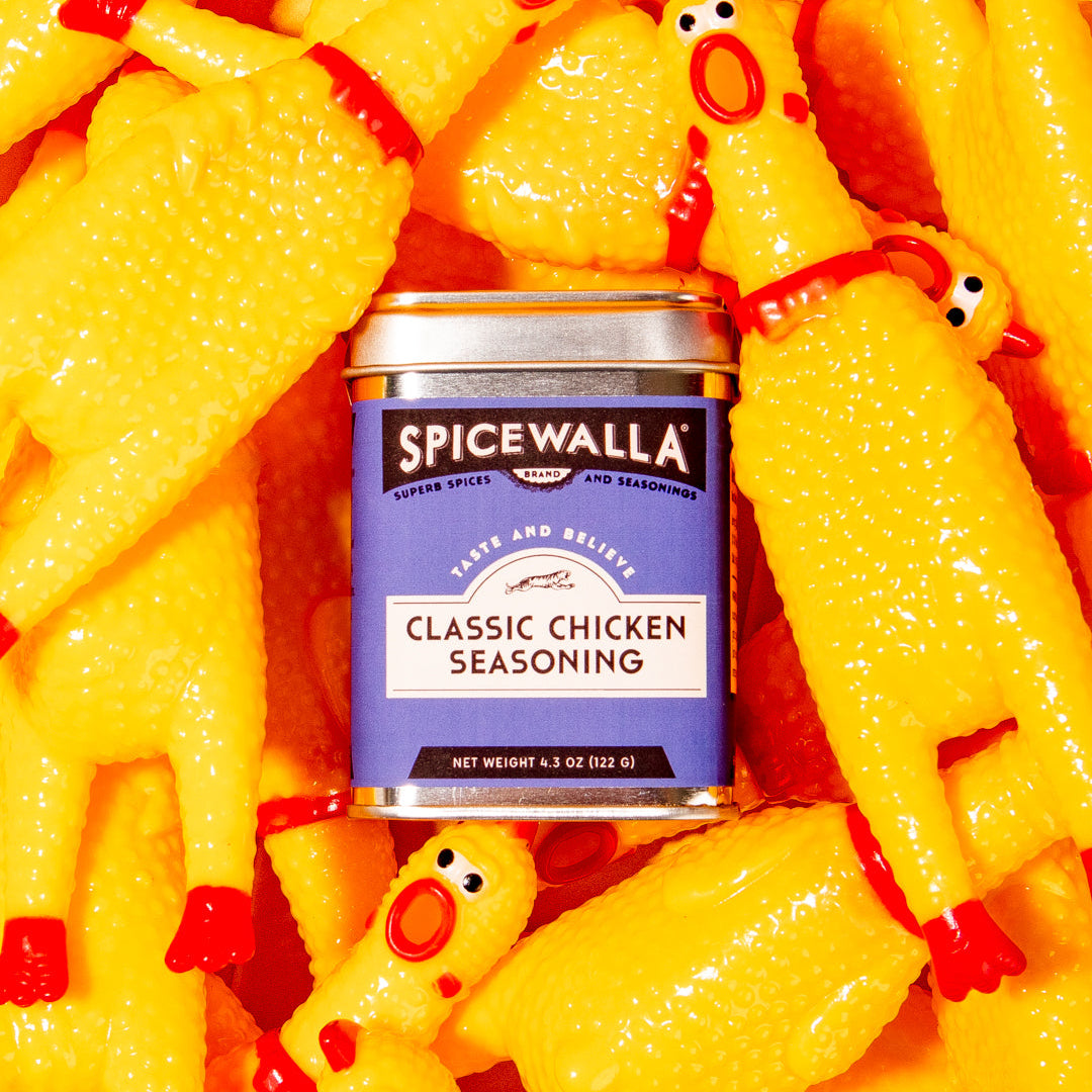 Spicewalla classic chicken seasoning can surrounded by yellow rubber chickens