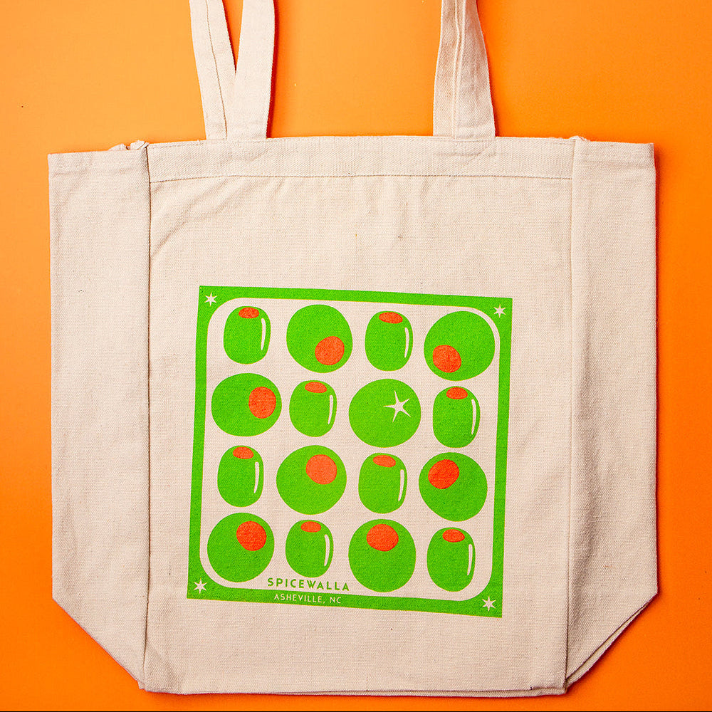 Beige tote bag with green pattern on an orange background