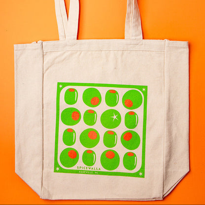 Beige tote bag with green pattern on an orange background
