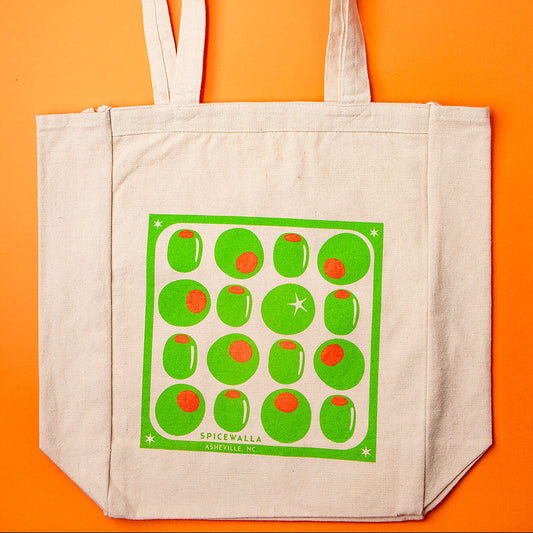 Beige tote bag with green pattern on an orange background