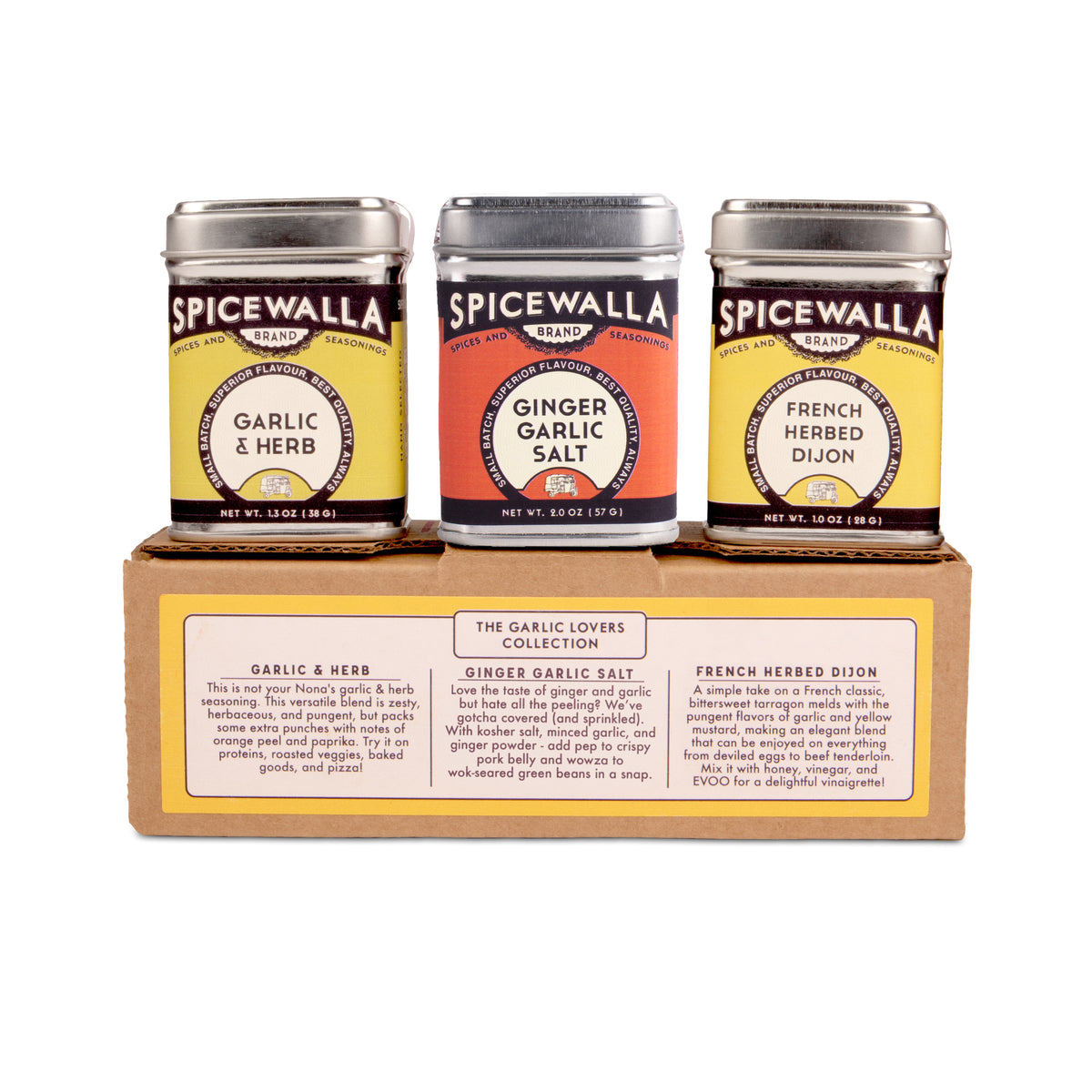 Three Spicewalla seasoning jars displayed on top of a cardboard gift box. The jars are labeled Garlic & Herb, Ginger Garlic Salt, and French Herbed Dijon, with silver lids and colorful labels.
