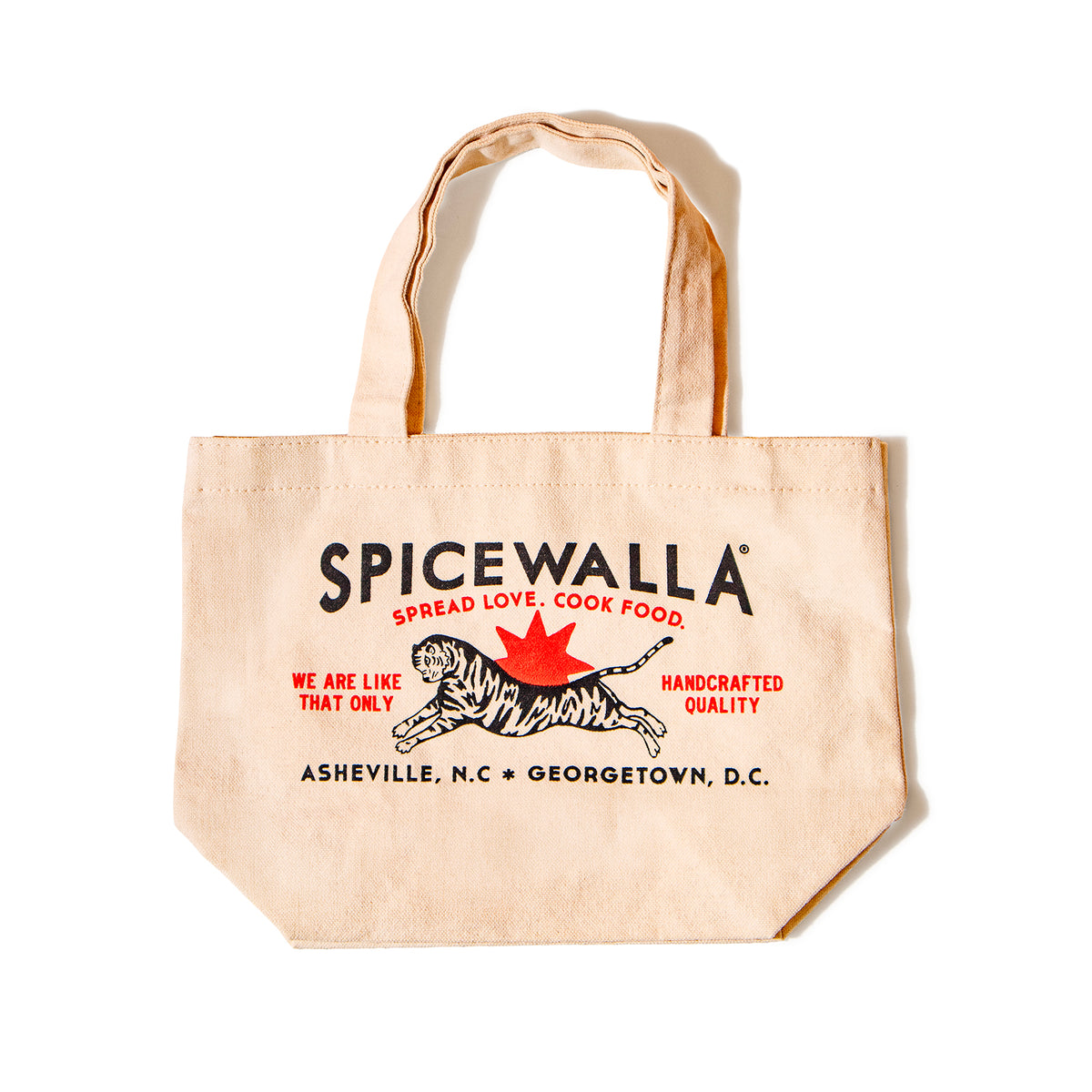 A beige canvas tote bag with 'SPICEWALLA' printed in black, a black-and-white tiger, and a red maple leaf in the center, photographed on a white background.