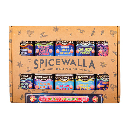 Spicewalla Spice Box set containing 12 small spice jars arranged in two rows on a brown cardboard box, with an Indian Cookbook included. The box features illustrations of spices and the brand name 'Spicewalla' prominently displayed.