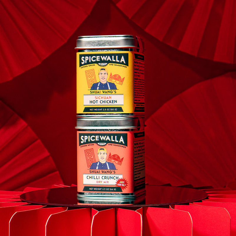 Two Spicewalla spice tins stacked on a red background