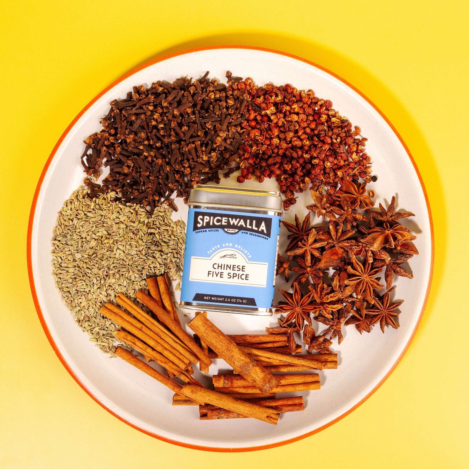 Spicewalla Chinese Five Spice packet on a plate with various spices on a yellow background