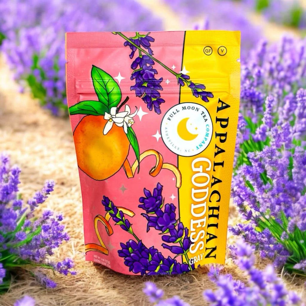 Appalachian Goddess tea bag with peach and lavender design in a field of lavender