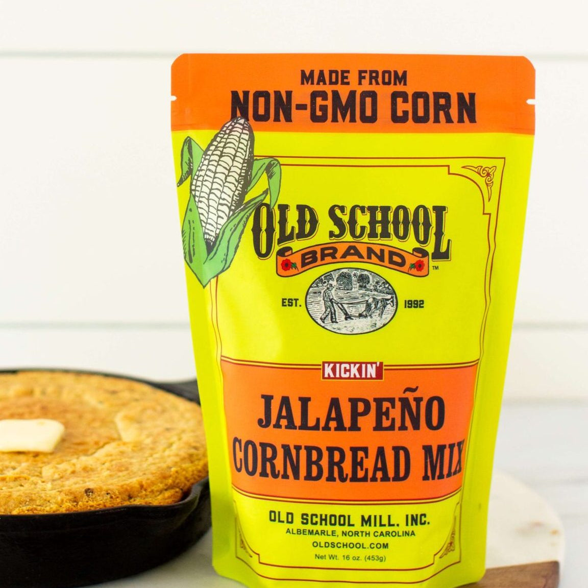 Old School Brand jalapeño cornbread mix packaging with a skillet of cornbread in the background.
