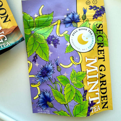 Tea package with floral design and text on a white surface